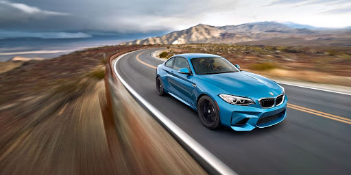 Blue BMW on a desert highway, an image from the marketing campaign for Pirelli